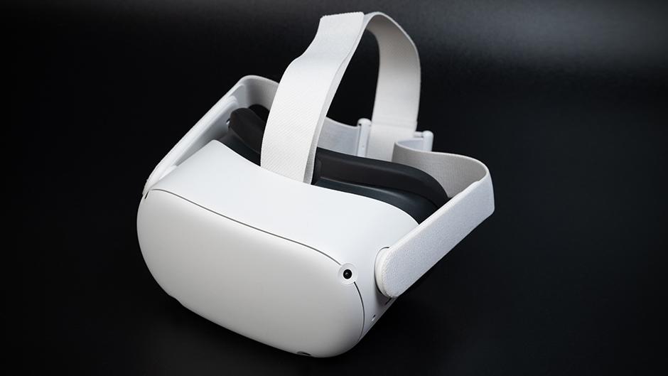 A white virtual reality headset on a black background