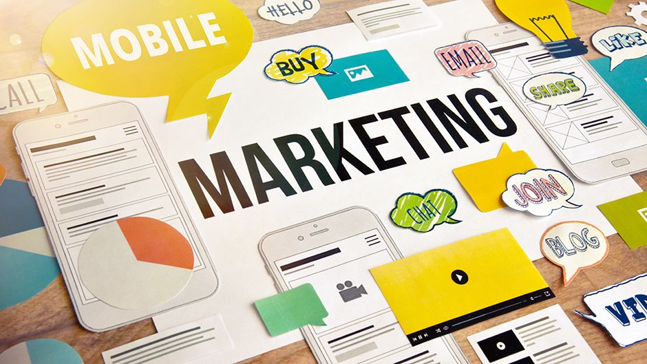 A collection of paper materials and the word Marketing