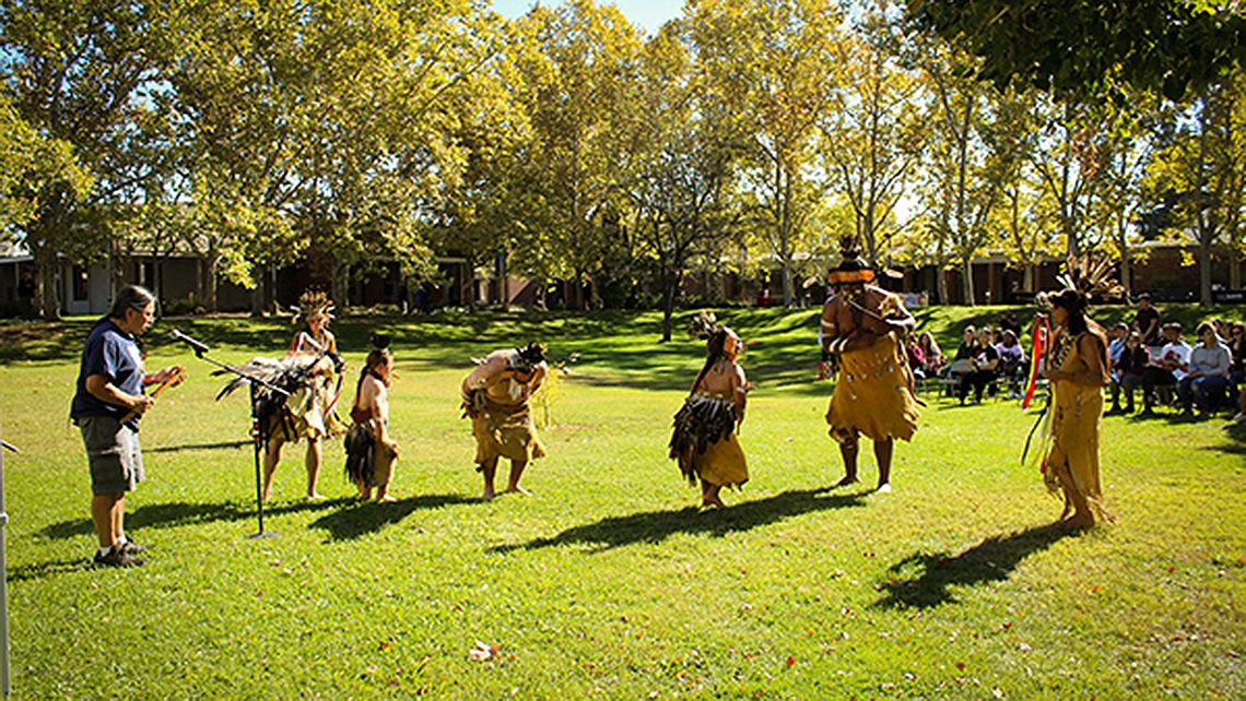 A group of dancers and a singer during Native American Heritage Week at CRC. Photo by November Rain Erwin.